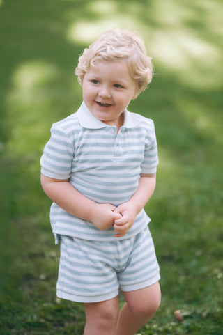 Toddler wearing unisex blue and white striped knit short set with collar, part of the Hollis Stripe Short Set by Little Harts.